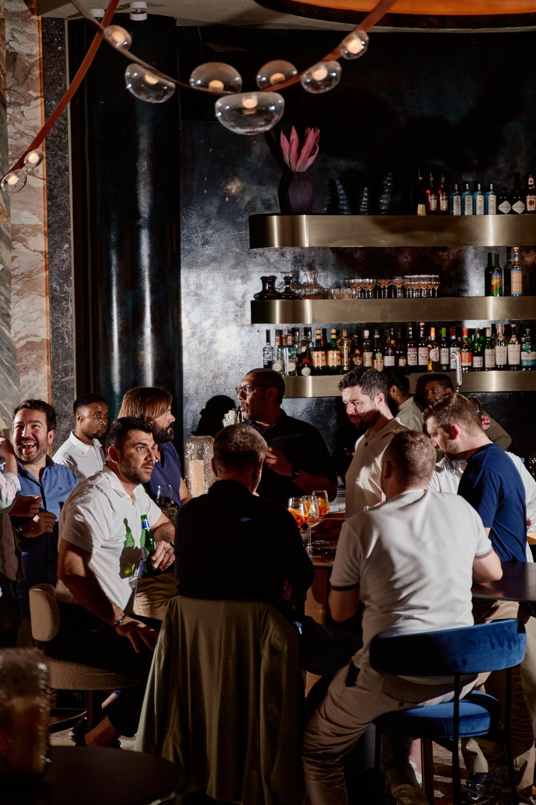 Guests gathered at a high table by the bar
