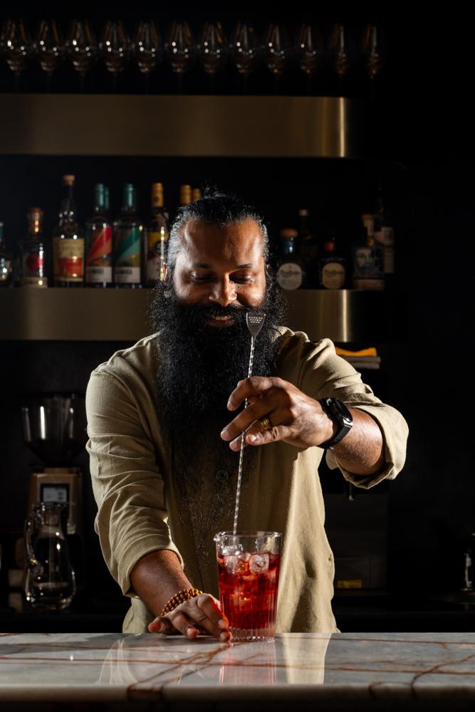 The bartender stirring a cocktail