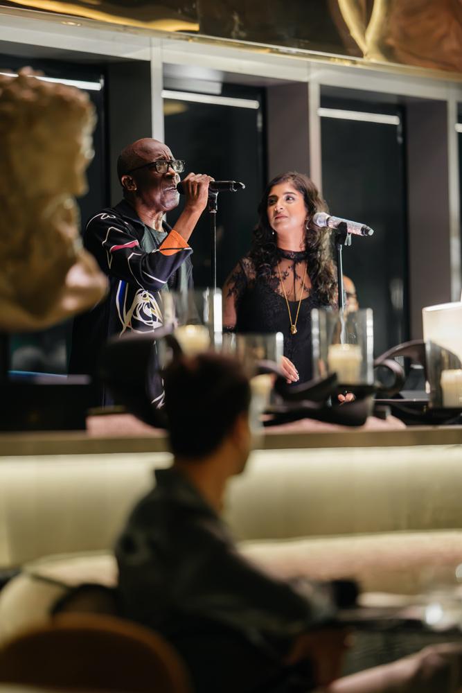 Two singers performing live at Fuoco